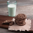 a stack of chocolate cookies and a glass of milk