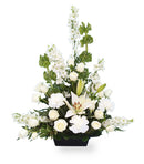white flower arrangement in a black container