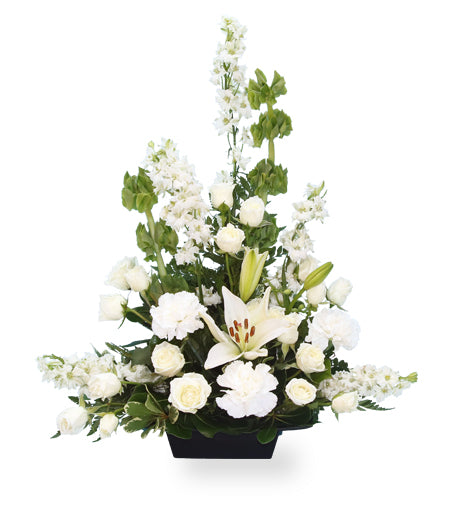 white flower arrangement in a black container