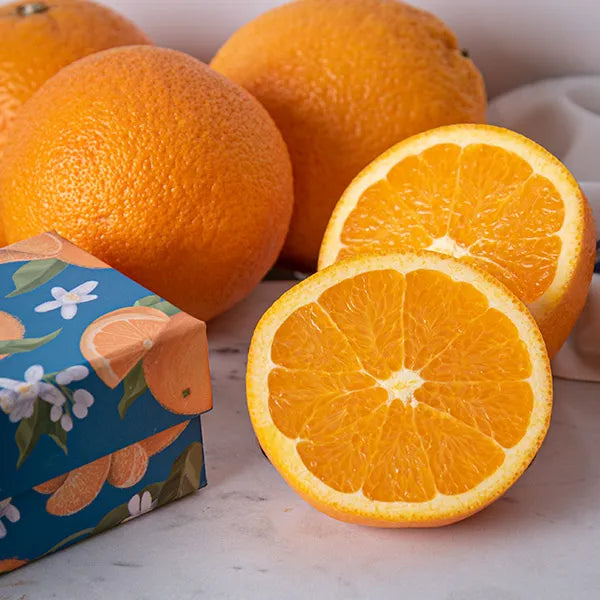 a group of oranges next to a box