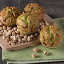 muffins and pistachios on a wooden board