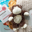 stuffed monkey next to cookies