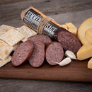 cheese, cookies and sausage on a wooden board