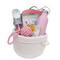 a white basket with pink objects in it