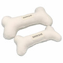 two white bone shape pillows with labels on them