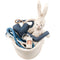 white stuffed rabbit in a basket with blue and white rope