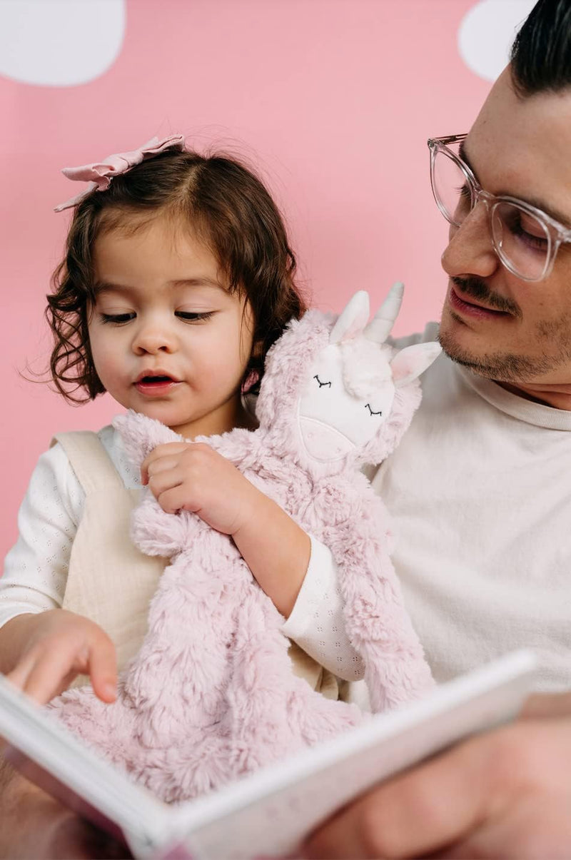 a person and a child holding a stuffed animal and a book