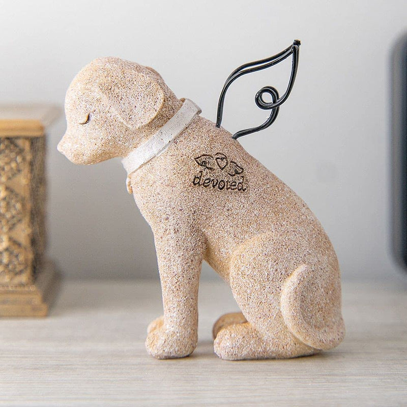 small statue of a dog with wings
