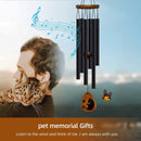cat sitting on a person's shoulder and wind chimes