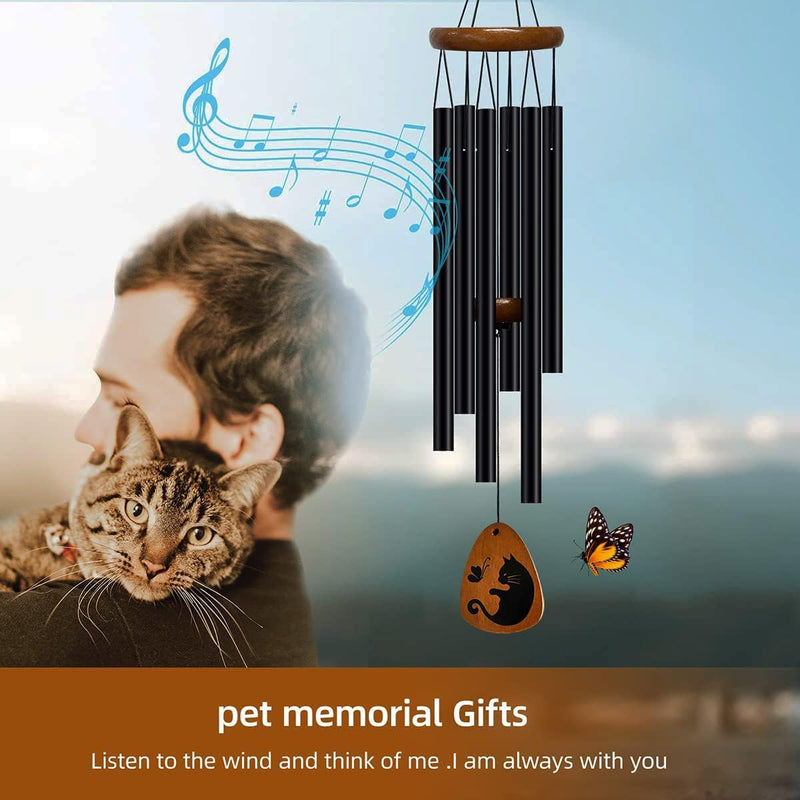 cat sitting on a person's shoulder and wind chimes