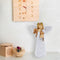 wooden clock with a white angel figurine holding dog figure and  flower