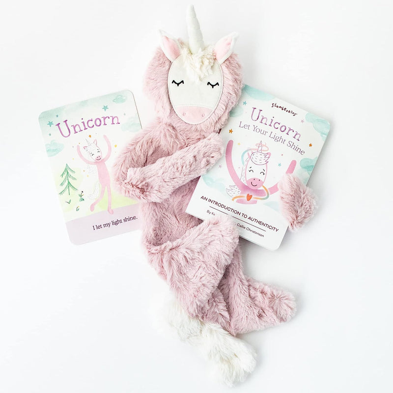a pink unicorn head animal and two books