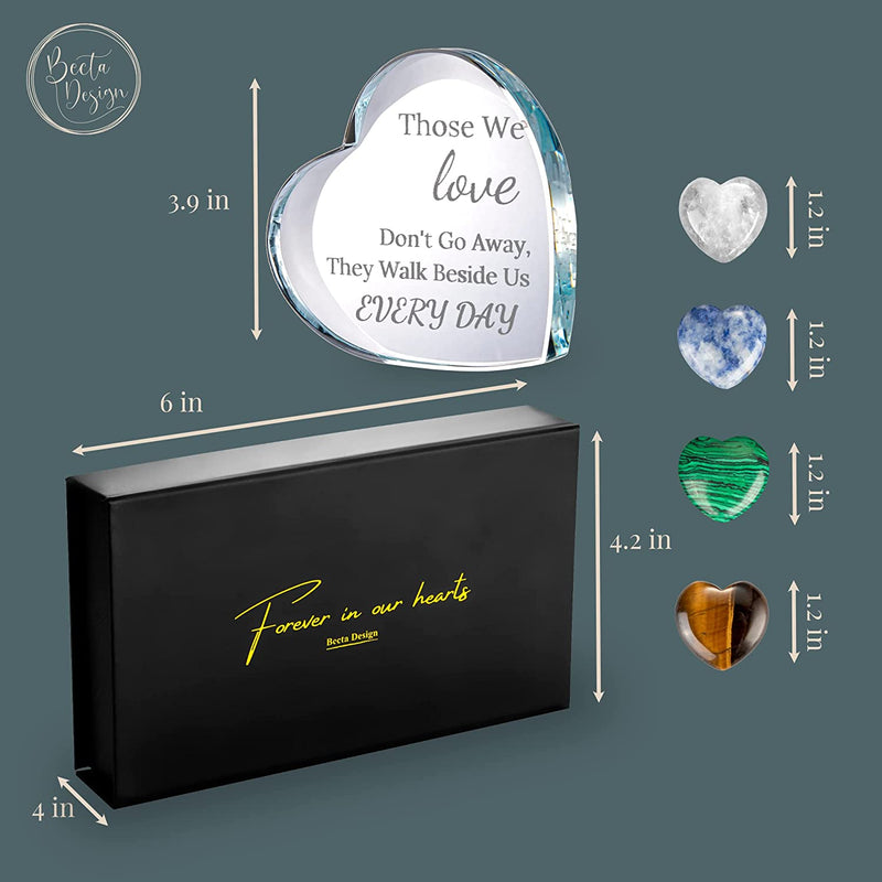 glass heart shaped objects and a black box with yellow text on it