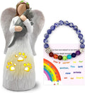 a statue of a catand angel  and a bracelet
