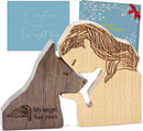 wooden figurine of a person and a dog
