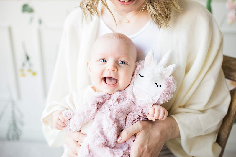 a person holding a baby and baby holding stuffed animal